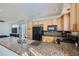 Open concept kitchen with stainless appliances and large island with granite countertop at 5534 Killarney St, Denver, CO 80249