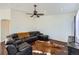 Spacious living room with a ceiling fan, recessed lights and beautiful hard wood floors at 5534 Killarney St, Denver, CO 80249