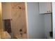 Bright bathroom featuring a shower-tub combo, neutral walls and tile with white cabinets at 4460 Columbine St, Denver, CO 80216