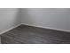 Updated bedroom with gray vinyl flooring, white baseboards, and neutral wall paint at 4460 Columbine St, Denver, CO 80216
