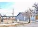 A quaint grey house featuring a well-maintained lawn and a welcoming street view at 4460 Columbine St, Denver, CO 80216