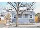 Charming grey home with a stone foundation, well-maintained lawn, and welcoming curb appeal at 4460 Columbine St, Denver, CO 80216