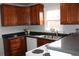 Beautiful kitchen with granite countertops, stainless steel sink, white appliances, and wood cabinets at 4460 Columbine St, Denver, CO 80216