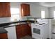 Modern eat-in kitchen with granite countertops, stainless sink, wood cabinets, and white appliances at 4460 Columbine St, Denver, CO 80216