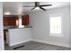 Inviting living room with new gray flooring, a ceiling fan, a breakfast bar, and access to the kitchen at 4460 Columbine St, Denver, CO 80216