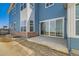 Backyard view, featuring a concrete patio and a sliding glass door at 920 Promenade Dr, Superior, CO 80027