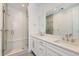 Bright bathroom featuring a double sink vanity and walk-in shower with stylish white tiling and glass door at 920 Promenade Dr, Superior, CO 80027