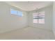 This bedroom has white walls, light carpet, and windows for natural light at 920 Promenade Dr, Superior, CO 80027