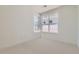 This bedroom has white walls, light carpet, and windows for natural light at 920 Promenade Dr, Superior, CO 80027