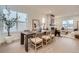 Bright dining room features a wooden table with seating for six, connecting to the living room at 920 Promenade Dr, Superior, CO 80027