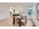 Open concept dining room with dark wood table, six chairs, and stylish decor with bright, natural light at 920 Promenade Dr, Superior, CO 80027
