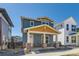 Two-story home featuring a covered porch with brick accents and blue siding at 920 Promenade Dr, Superior, CO 80027