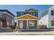 Charming two-story home featuring a covered porch with brick accents and a combination of blue and natural wood siding at 920 Promenade Dr, Superior, CO 80027