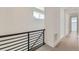 Hallway with hardwood floors, a railing, and white walls at 920 Promenade Dr, Superior, CO 80027
