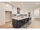 Spacious kitchen boasts a large island, white cabinets, stainless steel appliances, and hardwood floors at 920 Promenade Dr, Superior, CO 80027