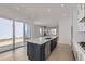 Modern kitchen features a large island, stainless steel appliances, and sliding door access to the outside at 920 Promenade Dr, Superior, CO 80027
