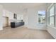 Open concept kitchen with a large navy island, white cabinets and bright windows at 920 Promenade Dr, Superior, CO 80027
