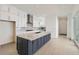 Modern kitchen featuring a spacious island, white cabinets, and stainless steel appliances at 920 Promenade Dr, Superior, CO 80027