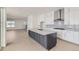 Spacious kitchen with stainless appliances, grey backsplash, white cabinets and a large island with a marble countertop at 920 Promenade Dr, Superior, CO 80027