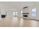 Bright living room with modern fireplace, light wood floors, and open layout at 920 Promenade Dr, Superior, CO 80027
