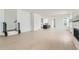 Spacious living room with light wood floors and open access to the kitchen and staircase at 920 Promenade Dr, Superior, CO 80027