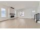 Bright living room featuring light wood floors, modern fireplace, and staircase at 920 Promenade Dr, Superior, CO 80027