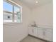 Bright mudroom with grey tile and white cabinets at 920 Promenade Dr, Superior, CO 80027