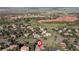 Aerial view showcases the neighborhood with lush landscape with red rock formations at 11039 Roxborough Dr, Littleton, CO 80125