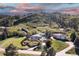 Aerial view showcasing the home's setting amidst lush greenery and neighboring houses, with a mountain backdrop at 11039 Roxborough Dr, Littleton, CO 80125