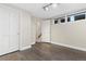 Basement features a pair of doors, wood look flooring, and a window near the ceiling at 11039 Roxborough Dr, Littleton, CO 80125