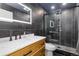 The bathroom features modern fixtures, including an illuminated mirror and a black tile shower at 11039 Roxborough Dr, Littleton, CO 80125