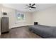 This bedroom features hardwood floors, large window with natural light, and ceiling fan at 11039 Roxborough Dr, Littleton, CO 80125