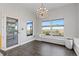 Dining room with chandelier, hardwood floors, and many windows with scenic views at 11039 Roxborough Dr, Littleton, CO 80125