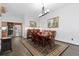 Formal dining room features a wood table, hardwood floors and modern lighting at 11039 Roxborough Dr, Littleton, CO 80125