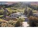 Stunning exterior elevation of home situated on a terraced lot with mountain views and mature trees at 11039 Roxborough Dr, Littleton, CO 80125