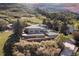 Exterior view of property surrounded by dense trees and greenery, set against a mountainside at 11039 Roxborough Dr, Littleton, CO 80125