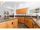 Modern kitchen with wooden cabinets, center island with cook top and hardwood floors at 11039 Roxborough Dr, Littleton, CO 80125