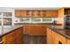 Eat in kitchen with wood cabinets, spacious countertops and views of the outdoors at 11039 Roxborough Dr, Littleton, CO 80125