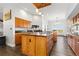Open kitchen with wood cabinets, center island and hard wood floors at 11039 Roxborough Dr, Littleton, CO 80125