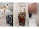 Well-equipped laundry room with modern washer/dryer, sink, and storage options at 11039 Roxborough Dr, Littleton, CO 80125