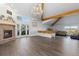 Bright living room featuring a fireplace, wood floors, and natural light from surrounding windows at 11039 Roxborough Dr, Littleton, CO 80125