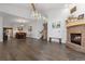 View of open concept living and dining room, fireplace, wood floors, and vaulted ceilings at 11039 Roxborough Dr, Littleton, CO 80125