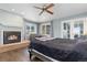 Spacious main bedroom with a fireplace, a ceiling fan, and private balcony access at 11039 Roxborough Dr, Littleton, CO 80125