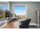 Comfortable home office features a modern workstation, dual monitors and breathtaking outdoor views at 11039 Roxborough Dr, Littleton, CO 80125