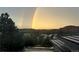 Spectacular scenic view of a double rainbow over the hills surrounding a rooftop at 11039 Roxborough Dr, Littleton, CO 80125