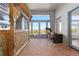 Bright sun room featuring brick floors, large windows, a telescope, and scenic views at 11039 Roxborough Dr, Littleton, CO 80125