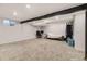 Spacious basement with carpeted floors, recessed lighting, and exposed beam at 3827 S Fraser St, Aurora, CO 80014