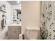 Charming bathroom featuring a modern vanity, a toilet and a shower/tub behind a curtain at 3827 S Fraser St, Aurora, CO 80014