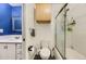 Neat bathroom featuring marble countertops, a toilet, and a bathtub with glass shower doors at 3827 S Fraser St, Aurora, CO 80014