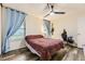 Cozy bedroom with hardwood floors, a ceiling fan, and ample natural light at 3827 S Fraser St, Aurora, CO 80014